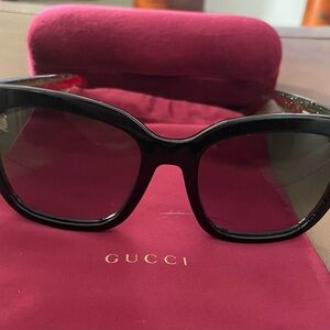 Gucci authentic Black Women's Sunglasses with Gold interlocking G accents.
